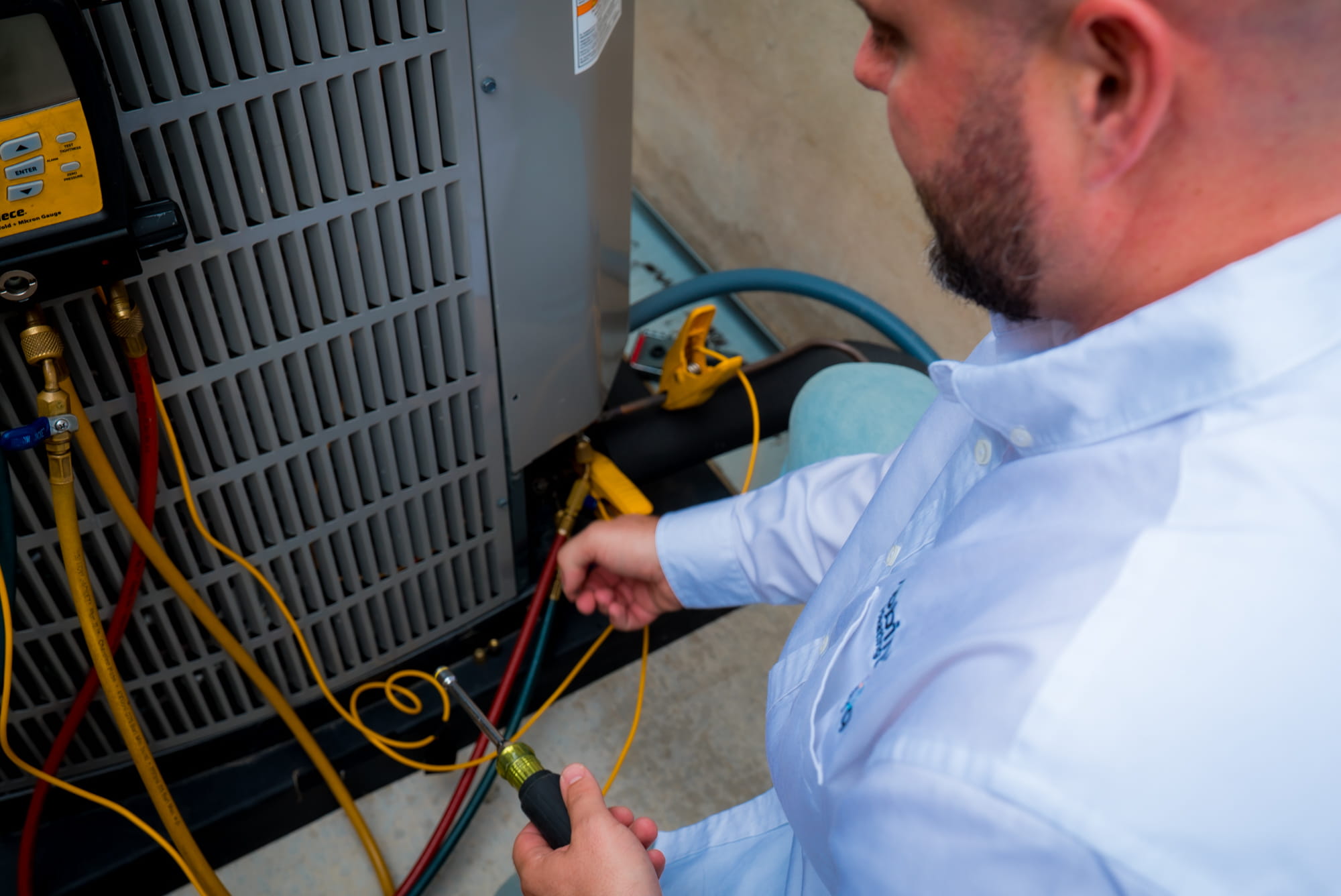 Technician installing air conditioning system